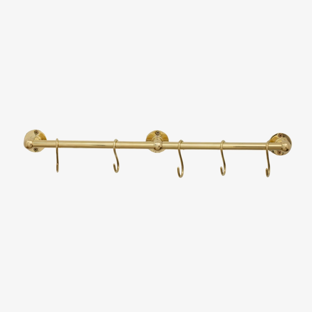 Polished brass wall-mounted rail with five S-shaped hooks and three round wall flanges