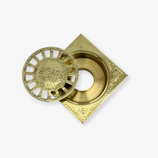 Brass square floor drain with hammered texture and removable round perforated strainer