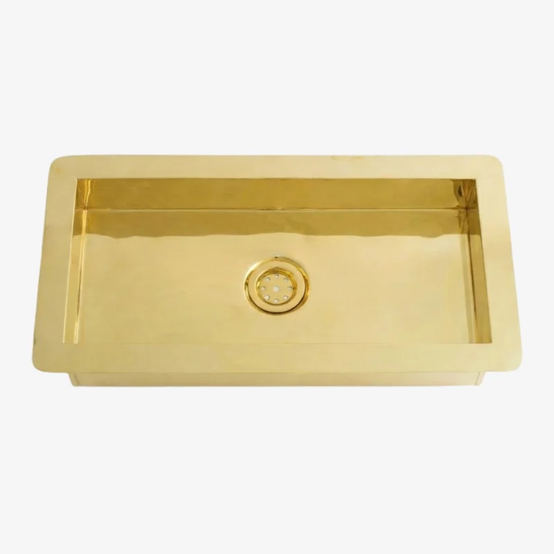 Gold Brass rectangular kitchen sink with a single basin and centered round drain