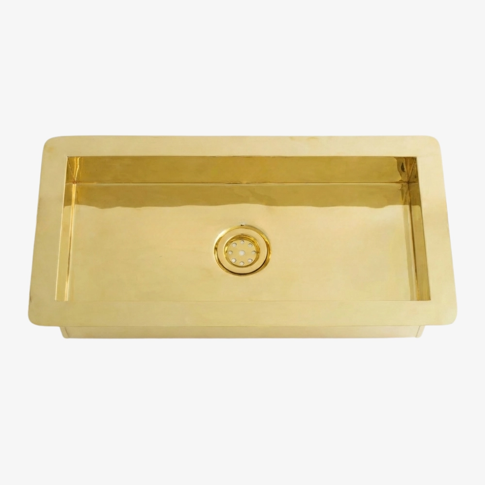 Gold Brass rectangular kitchen sink with a single basin and centered round drain