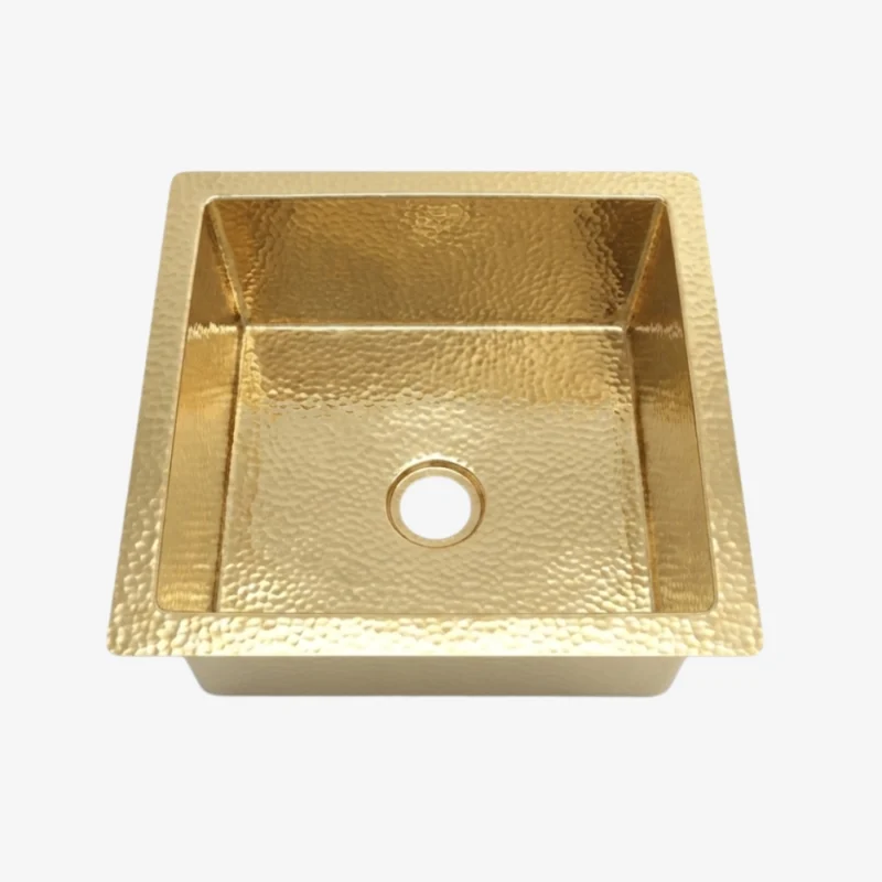 Square hammered brass single-basin sink with central drain hole and flat rim, shown top-down on a white background.