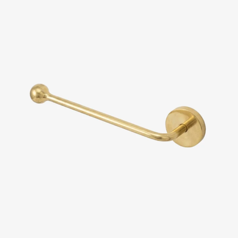 Wall-mounted brass toilet-paper holder with round wall plate and single curved arm ending in a ball on white background.